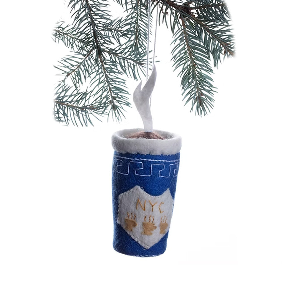 Guggenheim Museum Greek Coffee Cup Ornament: blue felt, NYC design with white swirl, hangs from a pine branch.