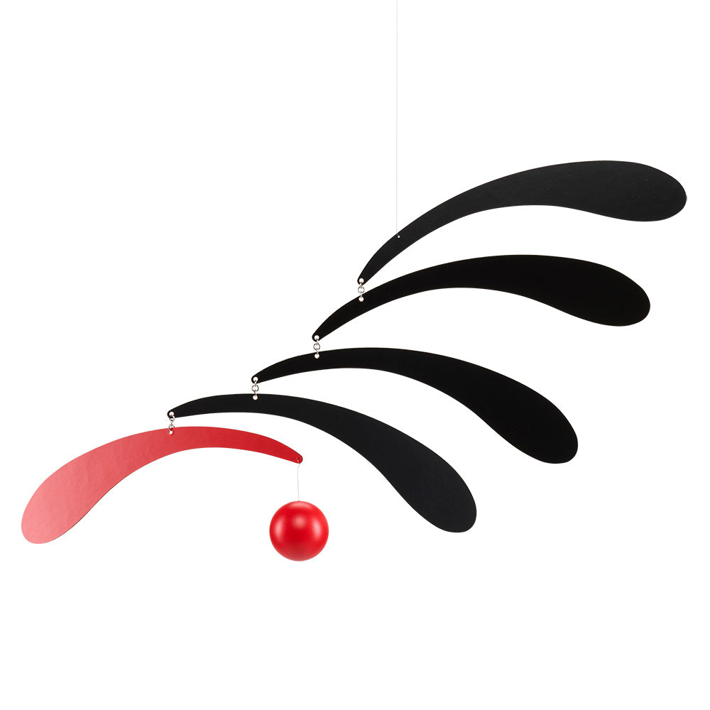 The Flowing Rhythm Mobile by Flensted features four curved shapes—three black, one red—with a red sphere hanging beneath the red shape, all linked by small metal joints for a modern look.