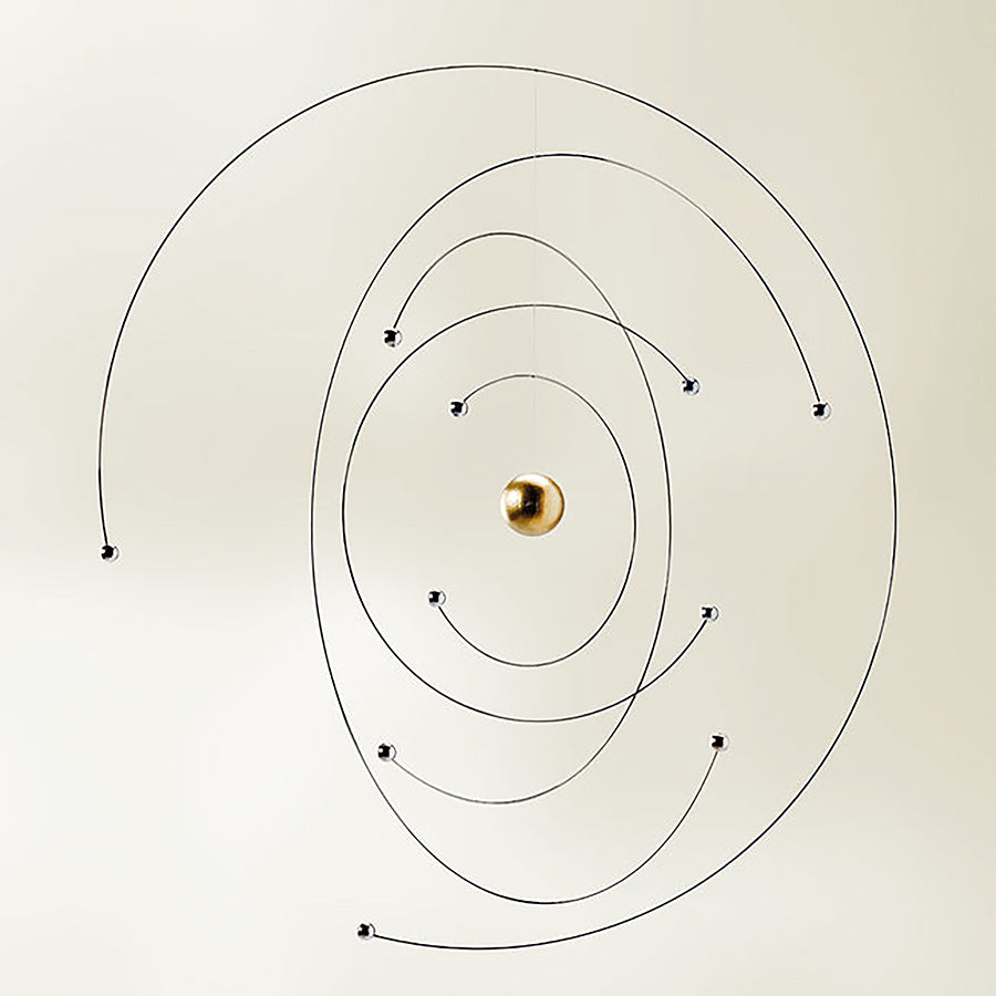 The Niels Bohr Atom Model Mobile by Flensted features a central gold sphere with thin black spiral wires and metallic orbiting balls, creating a minimalist, solar-system-inspired design ideal for Flensted Mobiles fans.