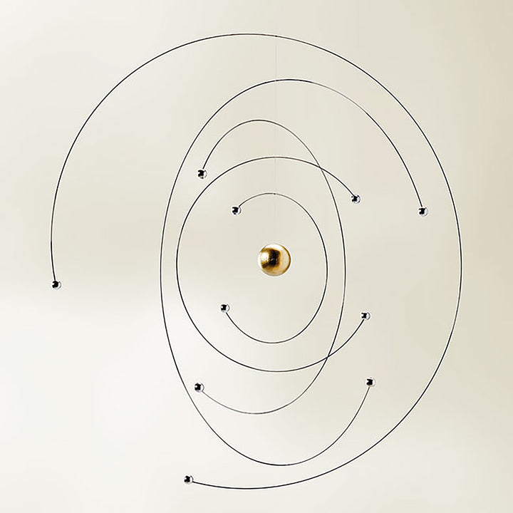 The Niels Bohr Atom Model Mobile by Flensted features a central gold sphere with thin black spiral wires and metallic orbiting balls, creating a minimalist, solar-system-inspired design ideal for Flensted Mobiles fans.
