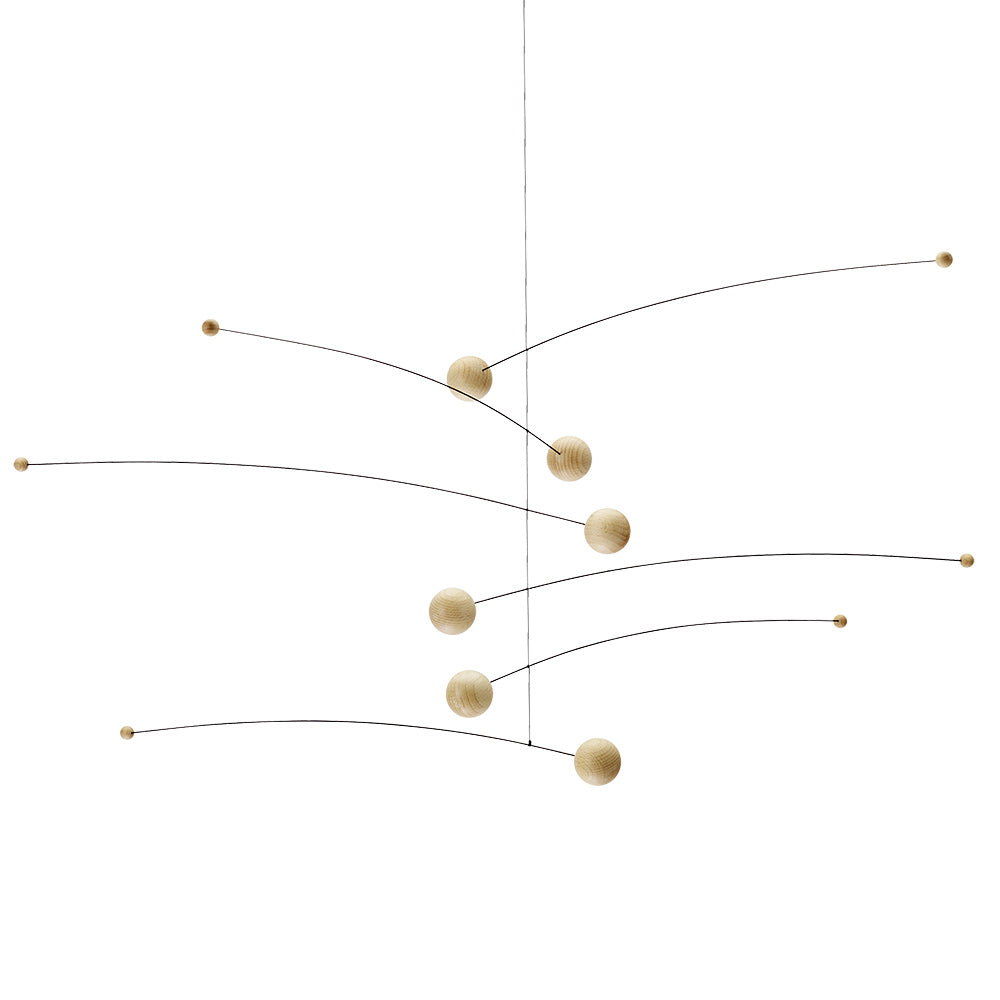 The Futura Mobile by Flensted features thin, curved metal rods and smooth, round wooden balls artfully balanced at each end—a minimalist piece ideal for adding modern style to any airy space.