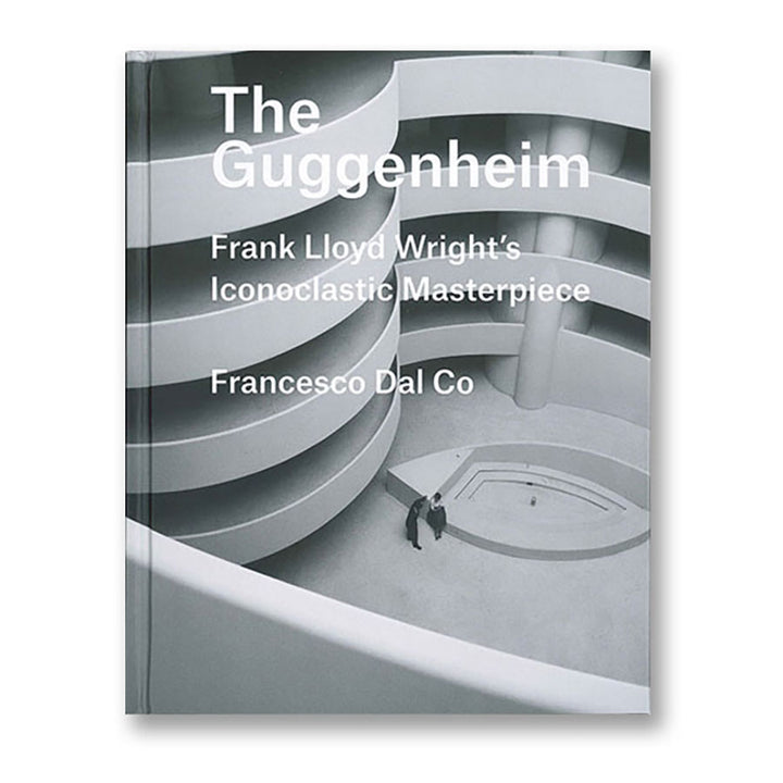 The cover of The Guggenheim: Frank Lloyd Wright's Iconoclastic Masterpiece shows a black-and-white image of the museum’s spiral interior in Manhattan, with an individual standing beneath it.