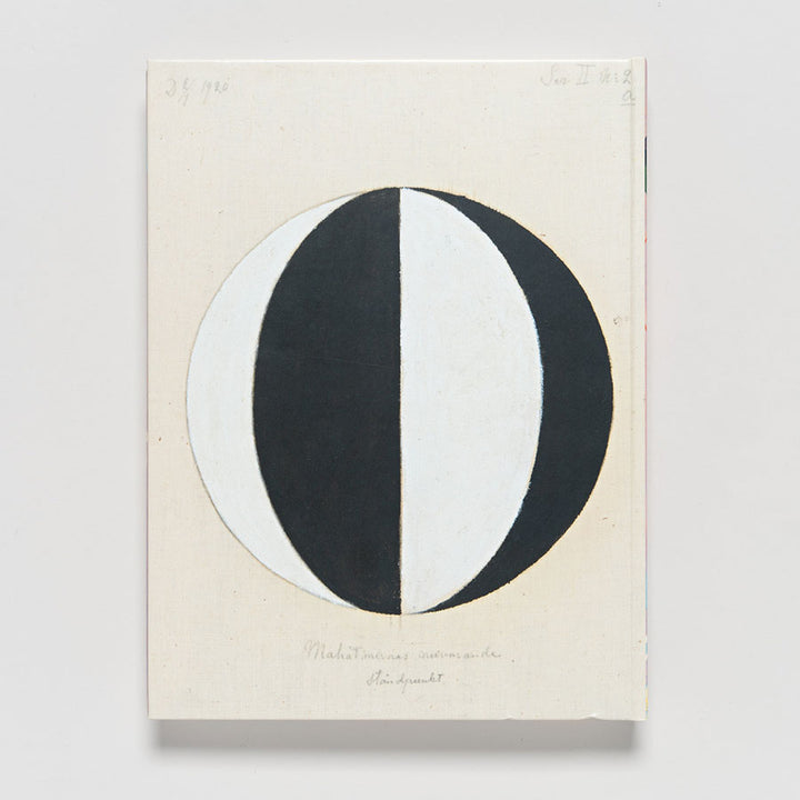 Featured in "Hilma af Klint: Paintings for the Future," a modernist abstract artwork shows a large circle split vertically into black and white halves, flanked by gray curves, set on an off-white background with faint handwritten notes above and below.