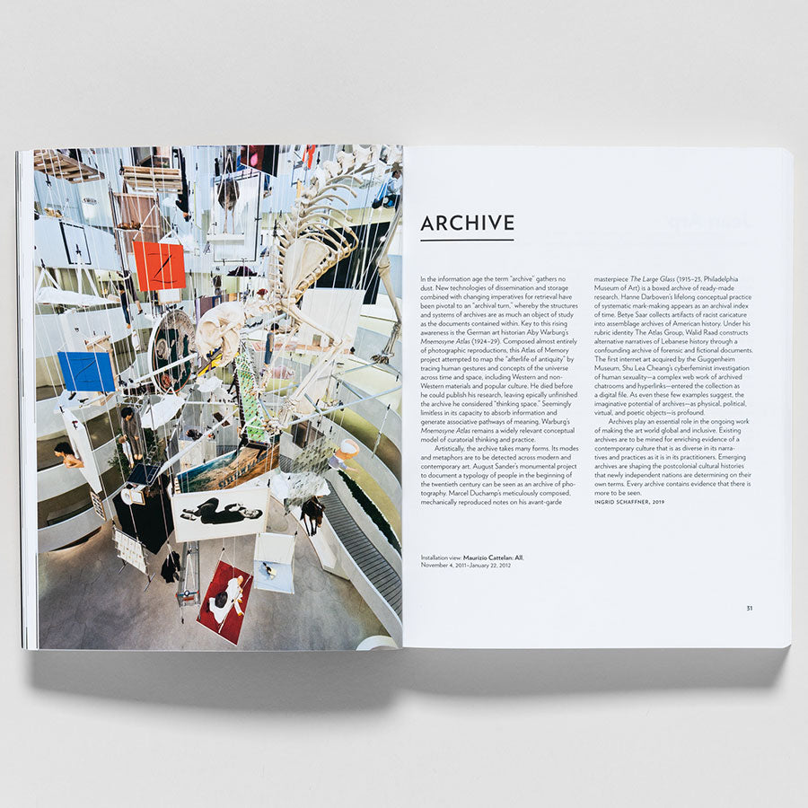 An open copy of Guggenheim Museum Collection: A to Z (revised edition) shows a vibrant art installation on the left page, curated by Nancy Spector and Vivien Greene; the right page features text under ARCHIVE on white.