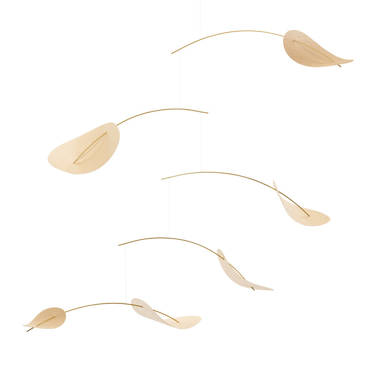 The Drifting Clouds Mobile by Flensted features five curved wooden shapes resembling leaves, suspended from thin rods in a balanced, minimalistic design inspired by Ole Flensted, creating an airy effect against a white background.