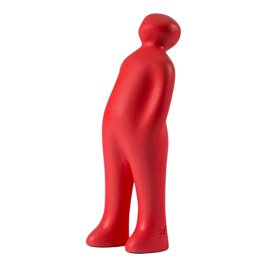 The Visitor Sculpture, Plus (Red) is a minimalistic, abstract red figure inspired by Guido Deleu’s design. It stands upright with a slight lean, resembling a modern ceramic figurine against a white background.