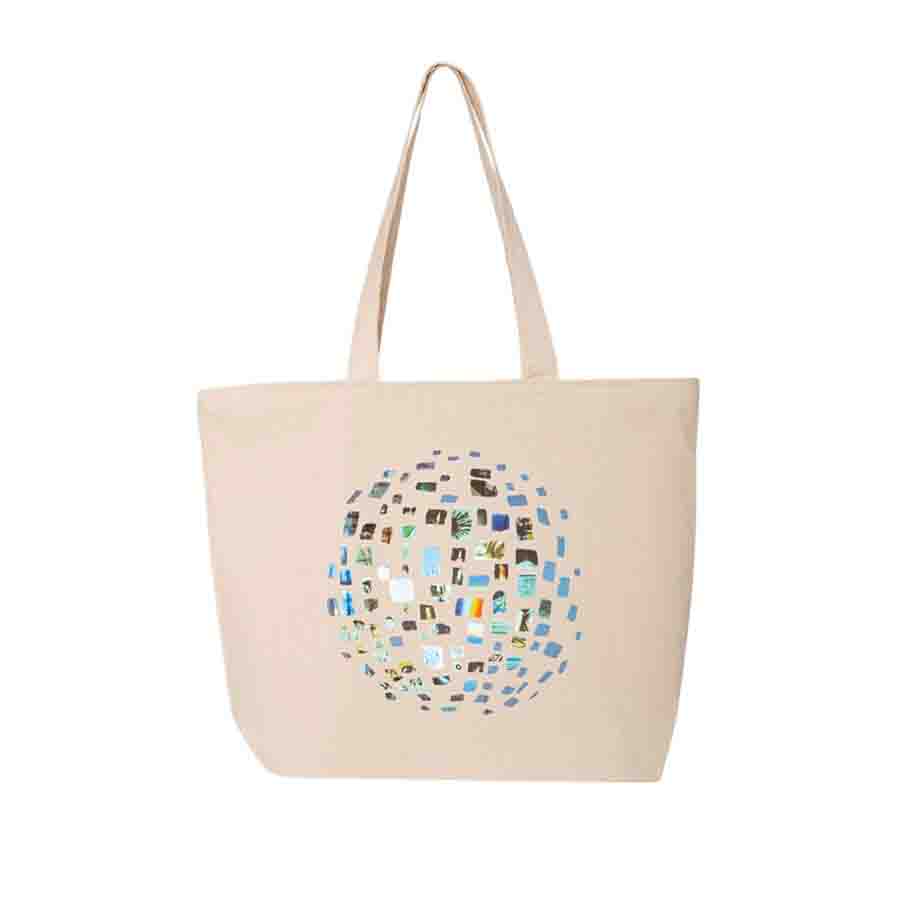 The Sarah Sze: Timelapse Exhibition Tote is a beige canvas travel bag with two handles and a colorful circular pattern of geometric shapes on the front—perfect for stylish daily use.