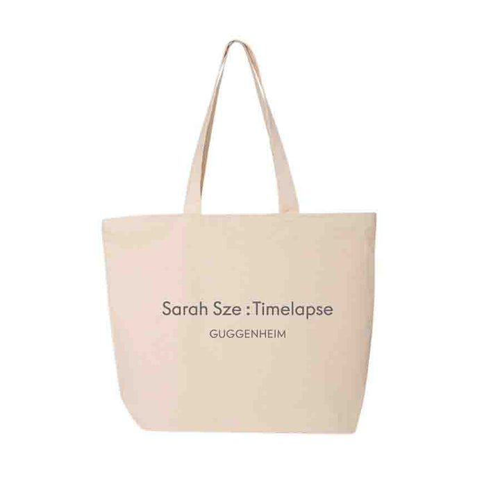 The Sarah Sze: Timelapse Exhibition Tote is a beige canvas bag from the Guggenheim Museum, featuring the exhibition title in black font—a stylish and practical choice for everyday use.