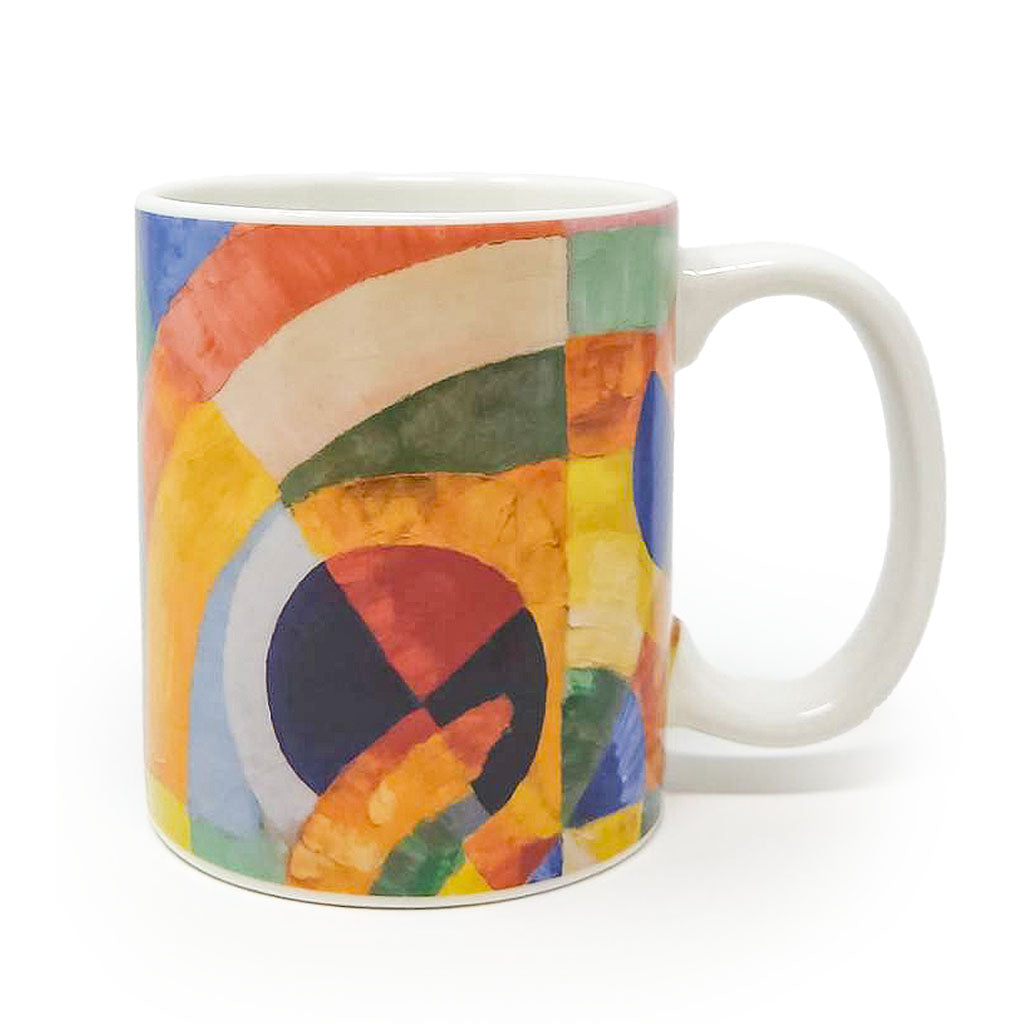 The Delaunay, Circular Forms Mug is a white ceramic mug featuring an abstract geometric design with overlapping circles and vibrant orange, yellow, blue, green, and red segments on a plain background.