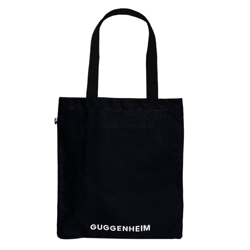 A black cotton tote with two handles, featuring "GRRRRRRRRRRR!!" in bold white letters near the bottom, inspired by Roy Lichtenstein's iconic style.