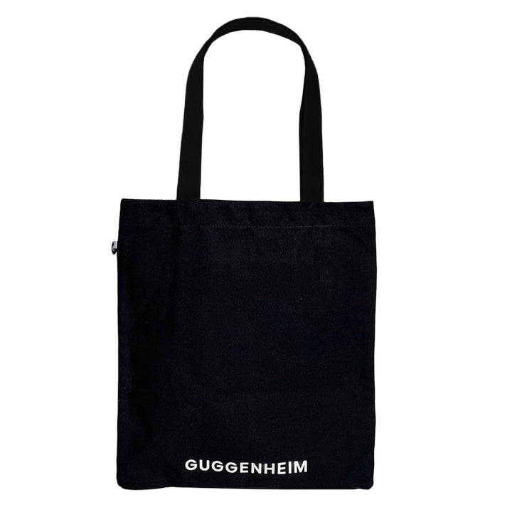 A black cotton tote with two handles, featuring "GRRRRRRRRRRR!!" in bold white letters near the bottom, inspired by Roy Lichtenstein's iconic style.