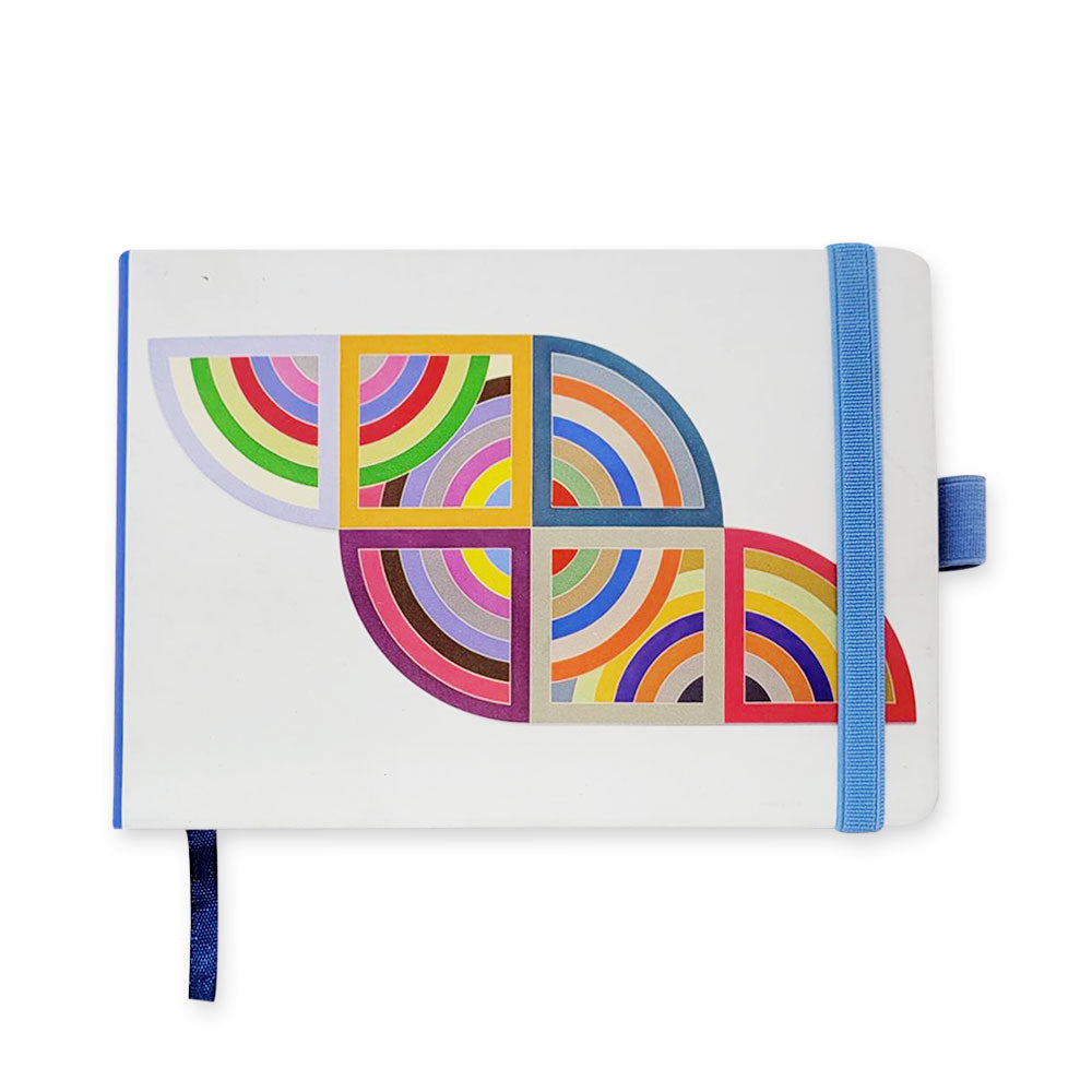 The Stella, Harran II Notebook is a white journal with a blue elastic band, blue pen holder, ribbon bookmark, and a vibrant geometric pattern of overlapping semicircles and rectangles—ideal for note-taking.