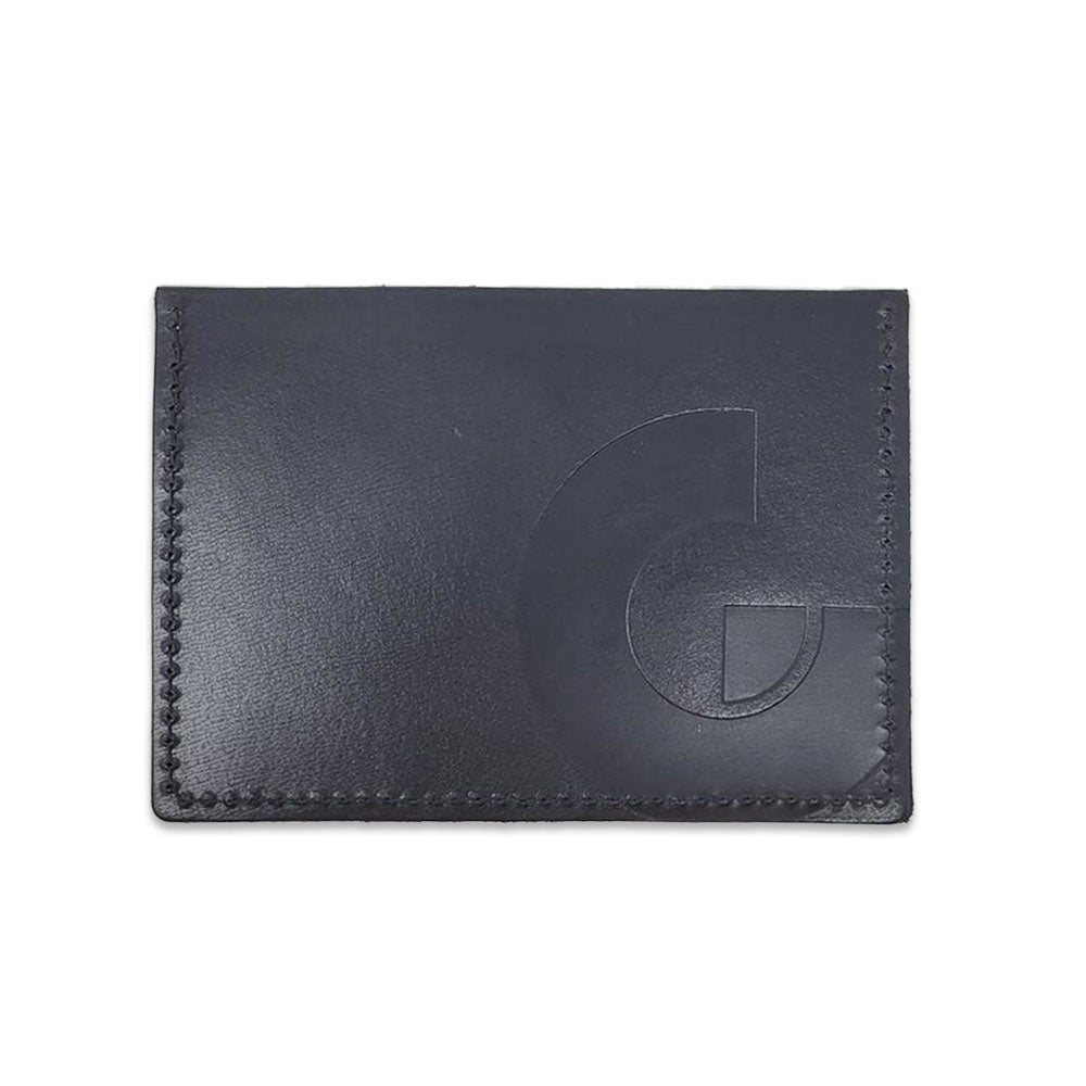 The Guggenheim Leather Card Holder features black leather, visible edge stitching, and an embossed geometric design on the right—an essential slim wallet option for sleek organization.
