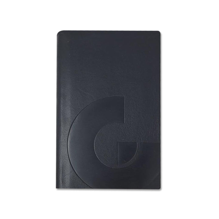 The Guggenheim Leather Pocket Notebook is a closed black notebook featuring a glossy, embossed geometric "G" design on the cover, shown against a white background.