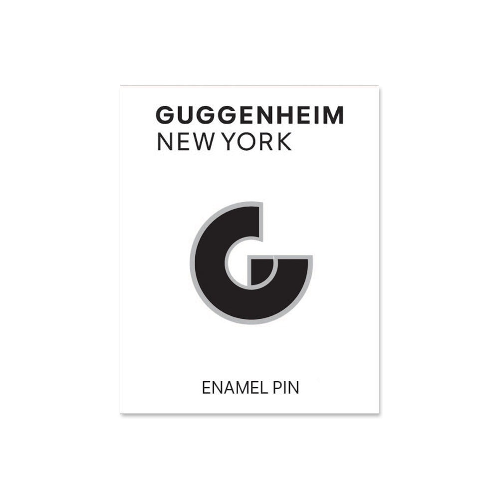 The Guggenheim Pin is a black and white enamel accessory in the shape of a stylized G, displayed on a card labeled "Guggenheim New York" at the top and "Enamel Pin" at the bottom—a wearable piece of architecture-inspired art.