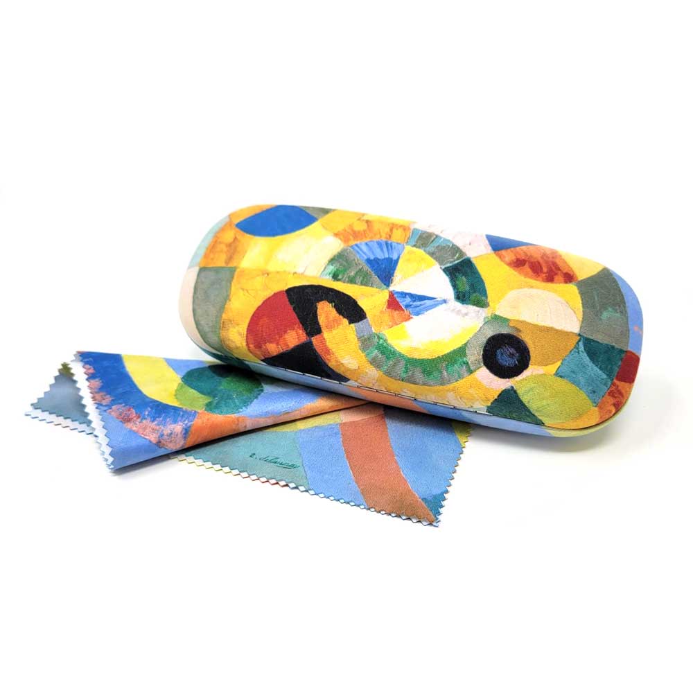The Delaunay, Circular Forms Eyeglass Case comes with a matching cloth, featuring vibrant yellow, blue, green, orange, and black geometric patterns inspired by Robert Delaunay’s vivid abstract art style.