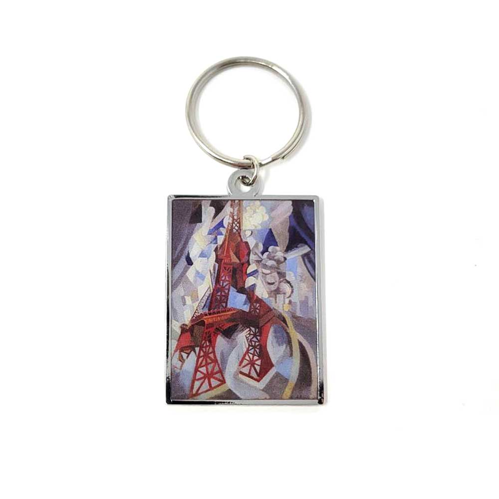 The Delaunay Eiffel Tower Keychain features a rectangular design with a metallic ring, showcasing an abstract red-tone tower against a blue and gray geometric background—a modern tribute to Parisian history.