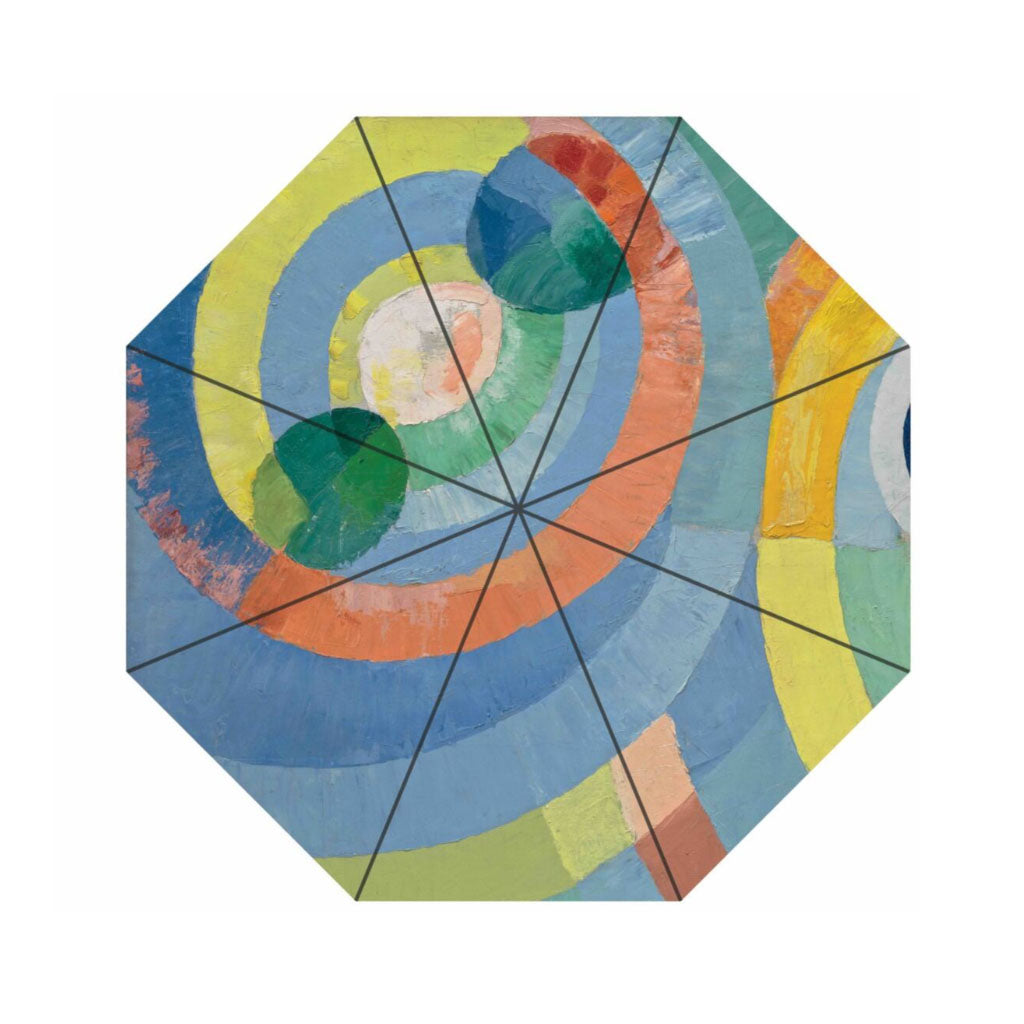 The Delaunay, Circular Forms Umbrella features an abstract octagonal design with concentric swirling bands of blue, green, yellow, orange, and pink. Straight lines divide the spiral pattern as vibrant colors blend in a striking artistic style.