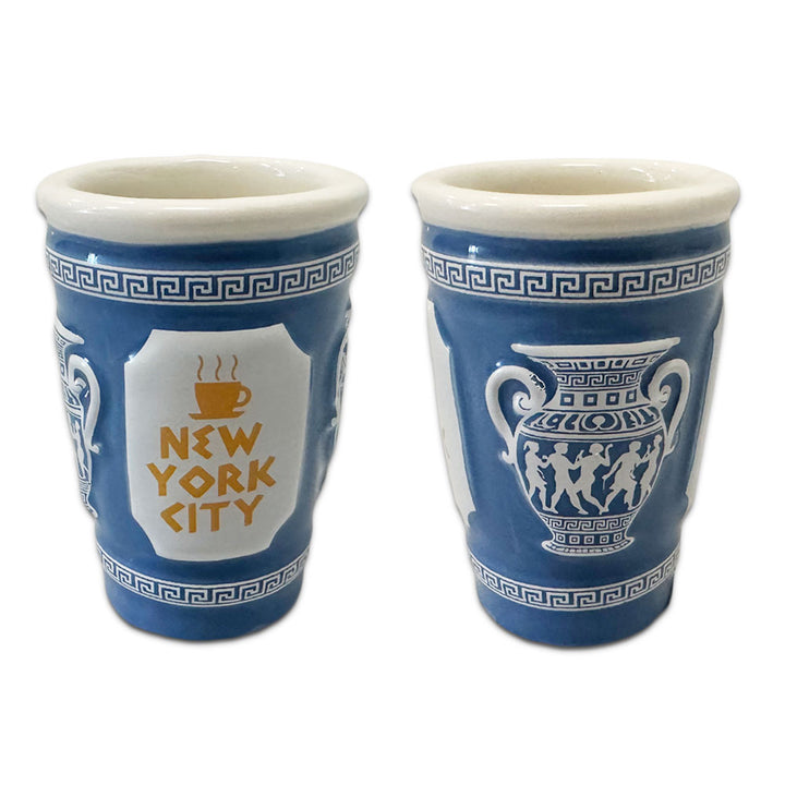Set of two blue and white 3D NYC Coffee Cup Shot Glasses with Greek-inspired patterns; one side shows a New York City coffee cup, the other a classical vase with dancing figures. Hand wash only.