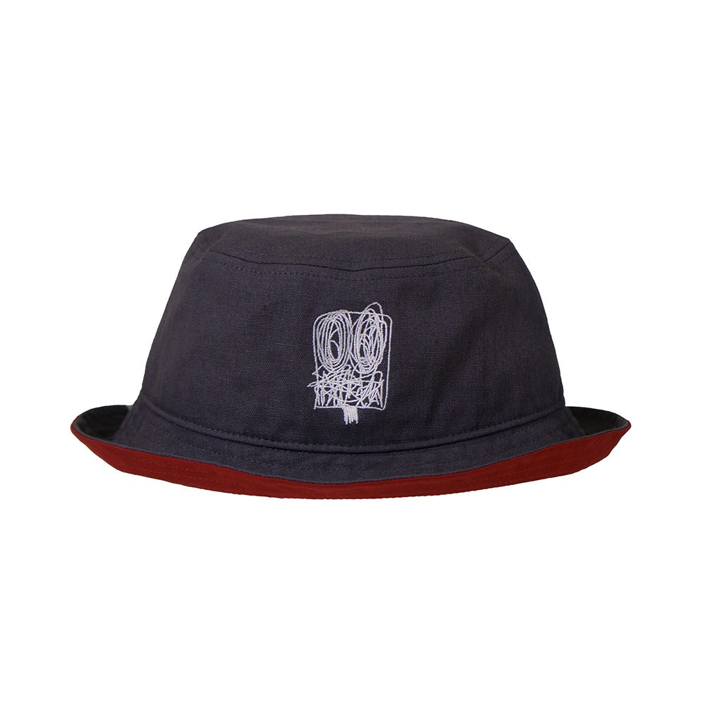 The Rashid Johnson Bucket Cap, Untitled Anxious Men, is a dark gray unisex bucket cap featuring an abstract white line drawing on the front and a maroon brim, inspired by Rashid Johnson’s expressive style.