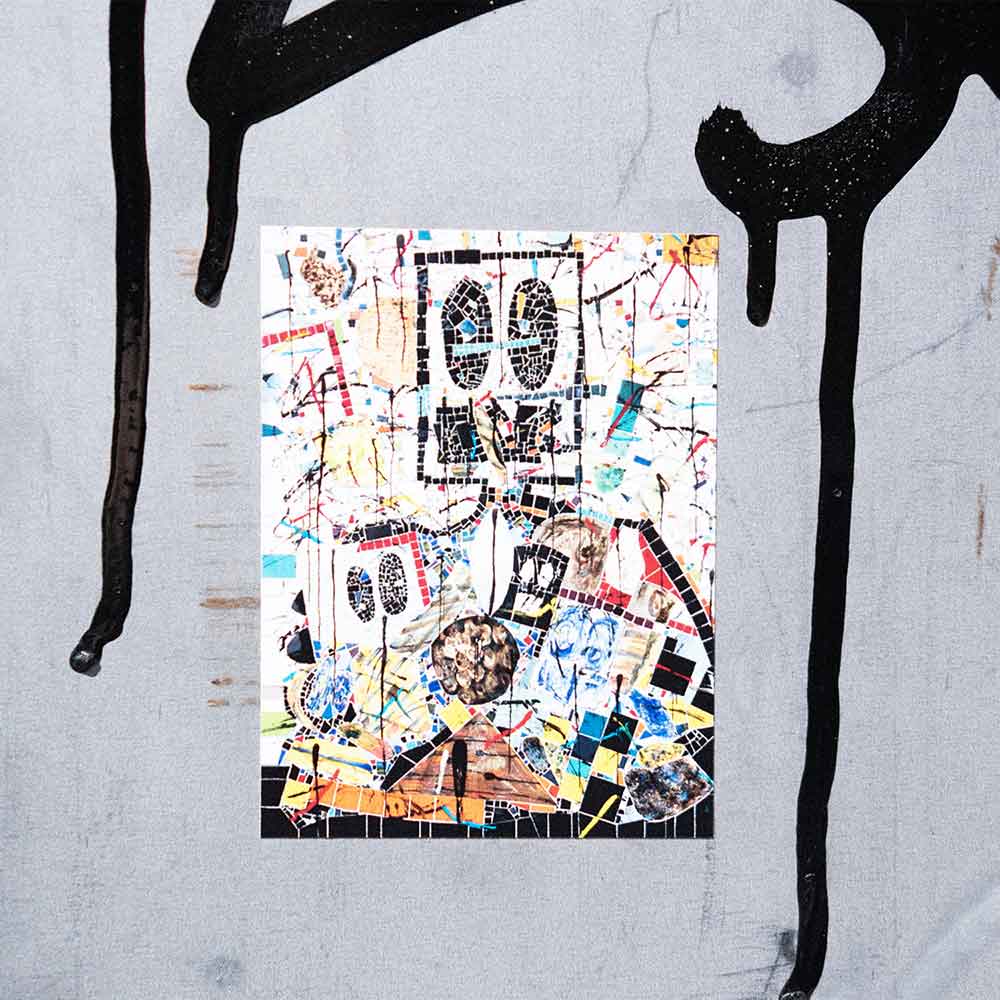 The Rashid Johnson Standing Broken Man Sticker, measuring 2.6" x 3.5", features bold shapes and playful, collage-inspired patterns on a colorful abstract design framed by black graffiti lines against a gray background.