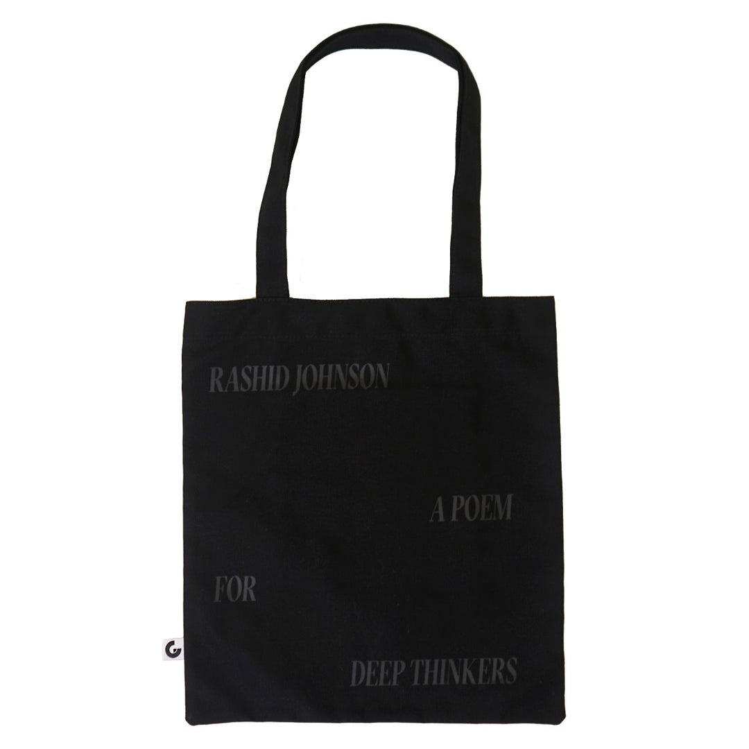 The Rashid Johnson Tote Bag, Broken Man, is a black cotton canvas tote featuring faint text—“Rashid Johnson,” “A Poem,” “For,” and “Deep Thinkers”—arranged across the front. A stylish must-have for contemporary art fans.