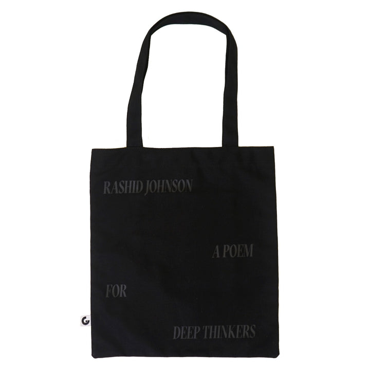 The Rashid Johnson Tote Bag, Broken Man, is a black cotton canvas tote featuring faint text—“Rashid Johnson,” “A Poem,” “For,” and “Deep Thinkers”—arranged across the front. A stylish must-have for contemporary art fans.