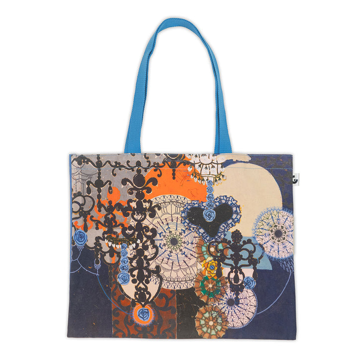 The Guggenheim Beatriz Milhazes Tote Bag, In Albis, is a canvas tote with blue handles showcasing an abstract design inspired by the artist, featuring lace-like doilies, blue roses, black shapes, and a bold orange circle.