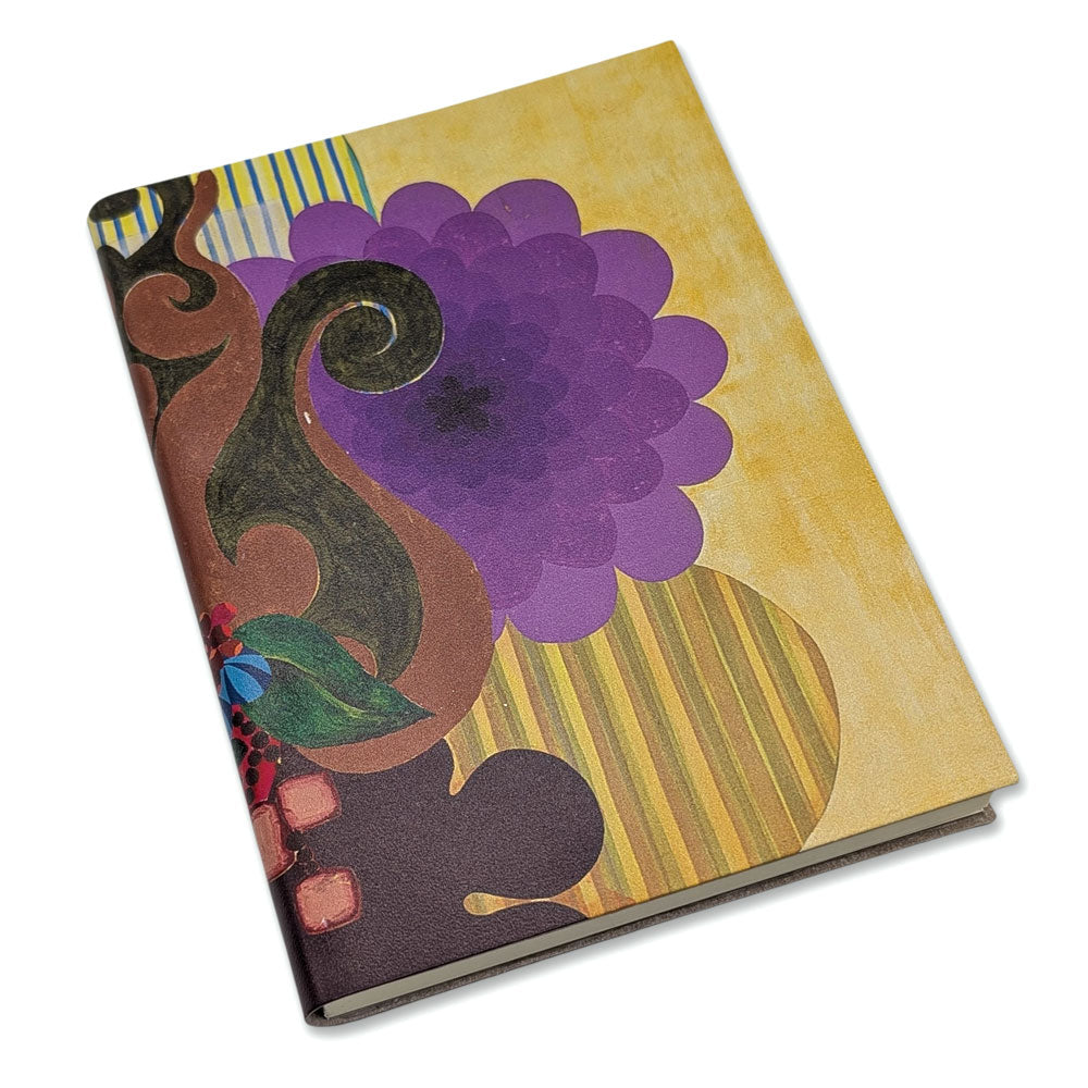 The Guggenheim Beatriz Milhazes Leather Journal features a closed, geometric abstract design with a vibrant cover of a large purple flower, brown swirls, and yellow stripes on a light background.