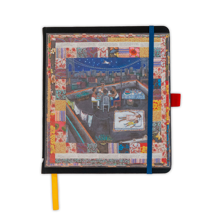 The Faith Ringgold Tar Beach Journal is a 6 x 8.5" hardcover notebook with a colorful patchwork border, featuring an illustration of rooftop dining at night. Includes unlined pages, blue elastic band, and yellow and red bookmarks for style.