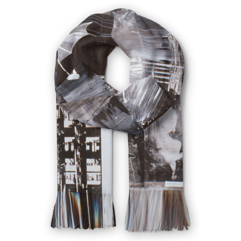 The Guggenheim Museum Robert Rauschenberg Barge Scarf features abstract black, gray, and white patterns with fringed ends.