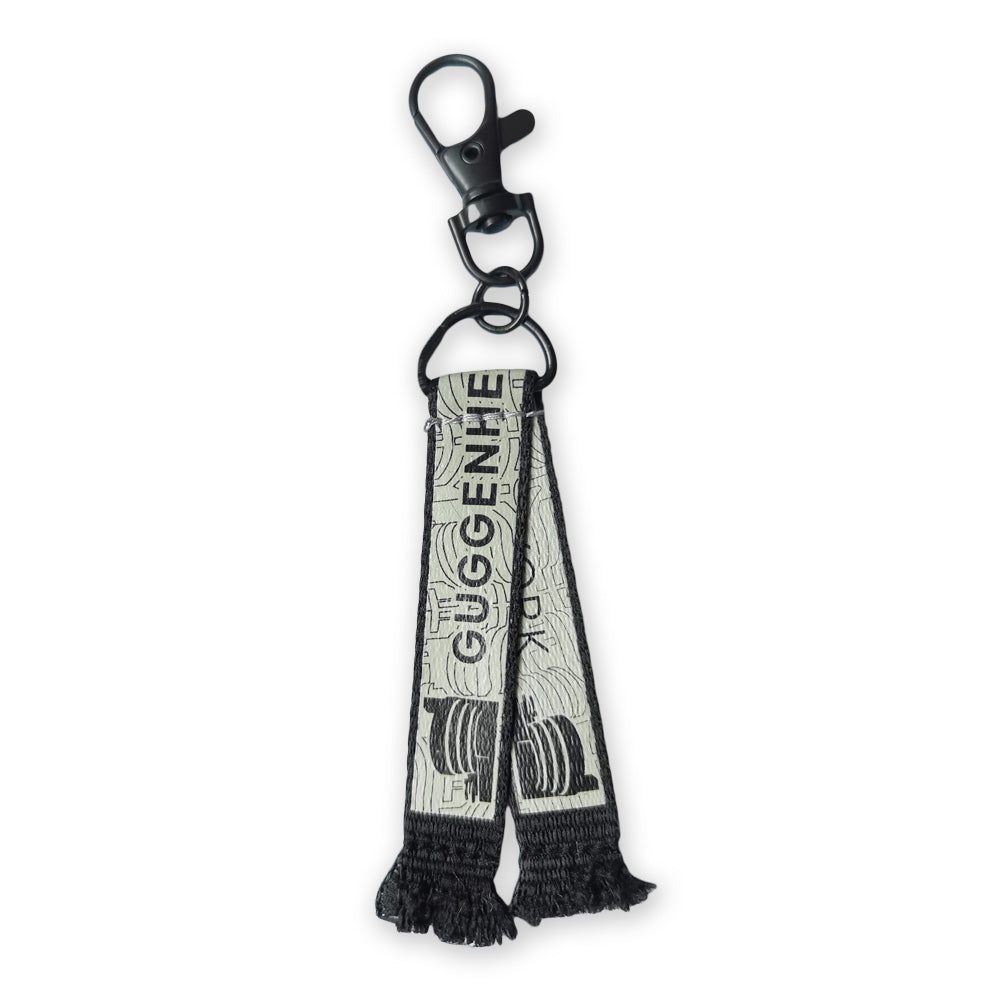 The Guggenheim Museum World Cup Scarf Keychain in black and white by Guggenheim Museum, shown on a white background.