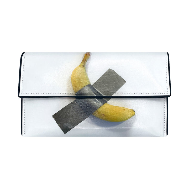 The Guggenheim Museum Banana Pop Art Clutch showcases a duct-taped banana for a bold, artful statement.