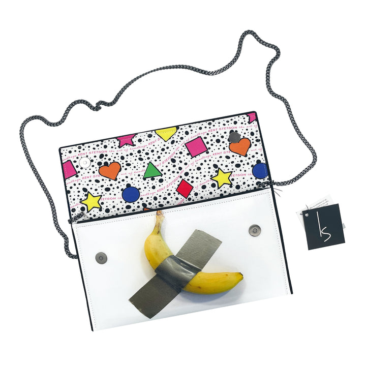 The Guggenheim Museum Banana Pop Art Clutch has a patterned interior and duct-taped banana in its clear front pocket.
