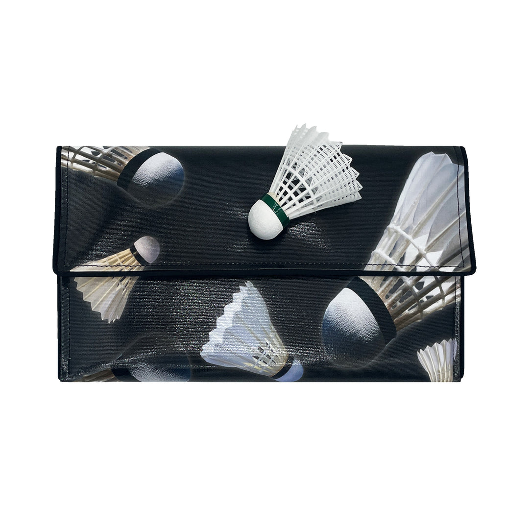 The Shuttlecock Pop Art Clutch by Guggenheim Museum is a black accessory with a shuttlecock pattern and 3D decor.