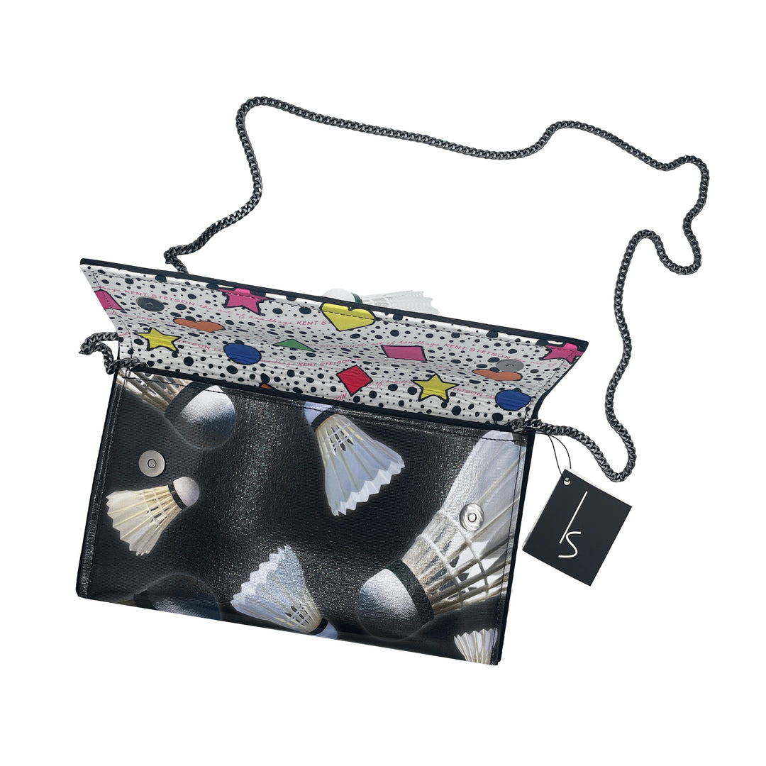 The Guggenheim Museum Shuttlecock Pop Art Clutch features a chain strap, colorful flap, and a black tag.