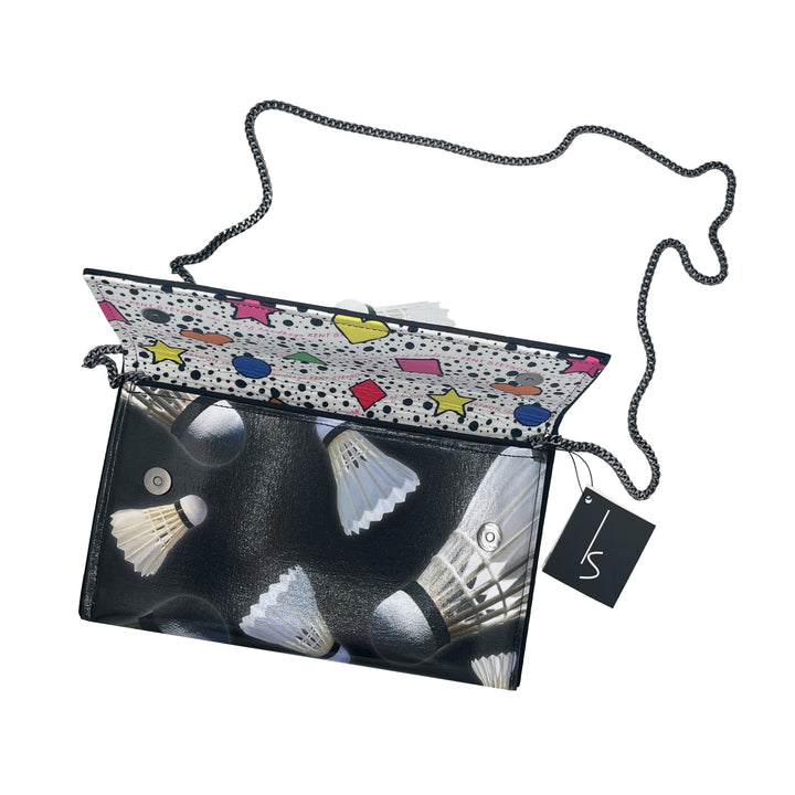 The Guggenheim Museum Shuttlecock Pop Art Clutch features a chain strap, colorful flap, and a black tag.
