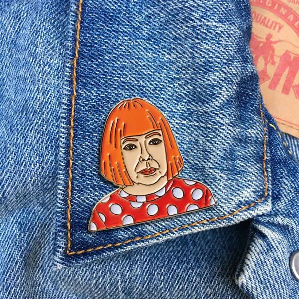 Guggenheim Museum's Yayoi Kusama Pin: orange bob, red polka-dot shirt, blue denim—perfect for art lovers.