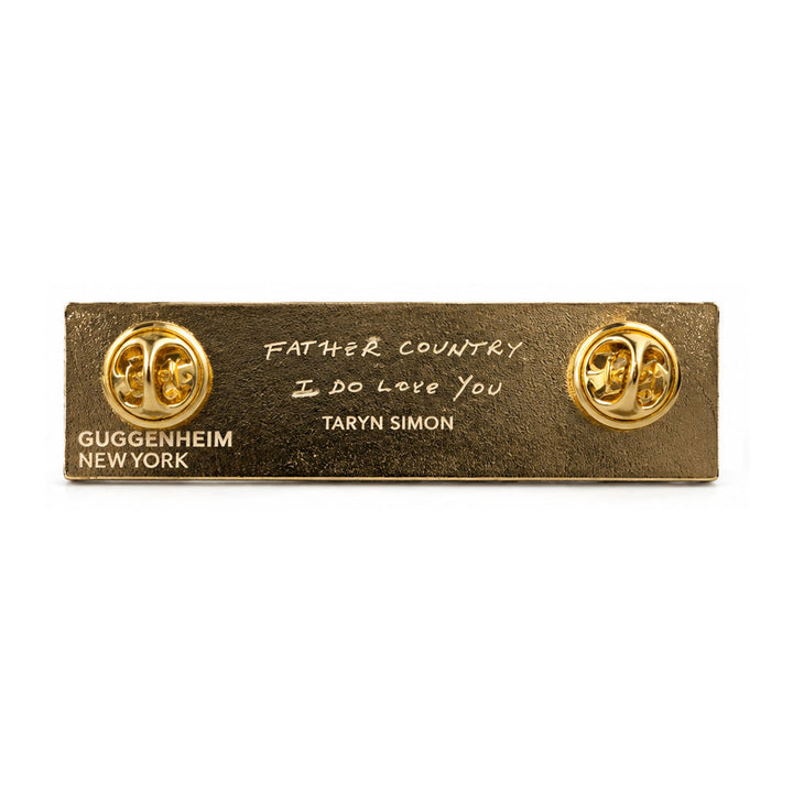 Guggenheim Museum Taryn Simon Striped Pin: rectangular gold-toned pin reading Father Country, I Do Love You, with two clasps.