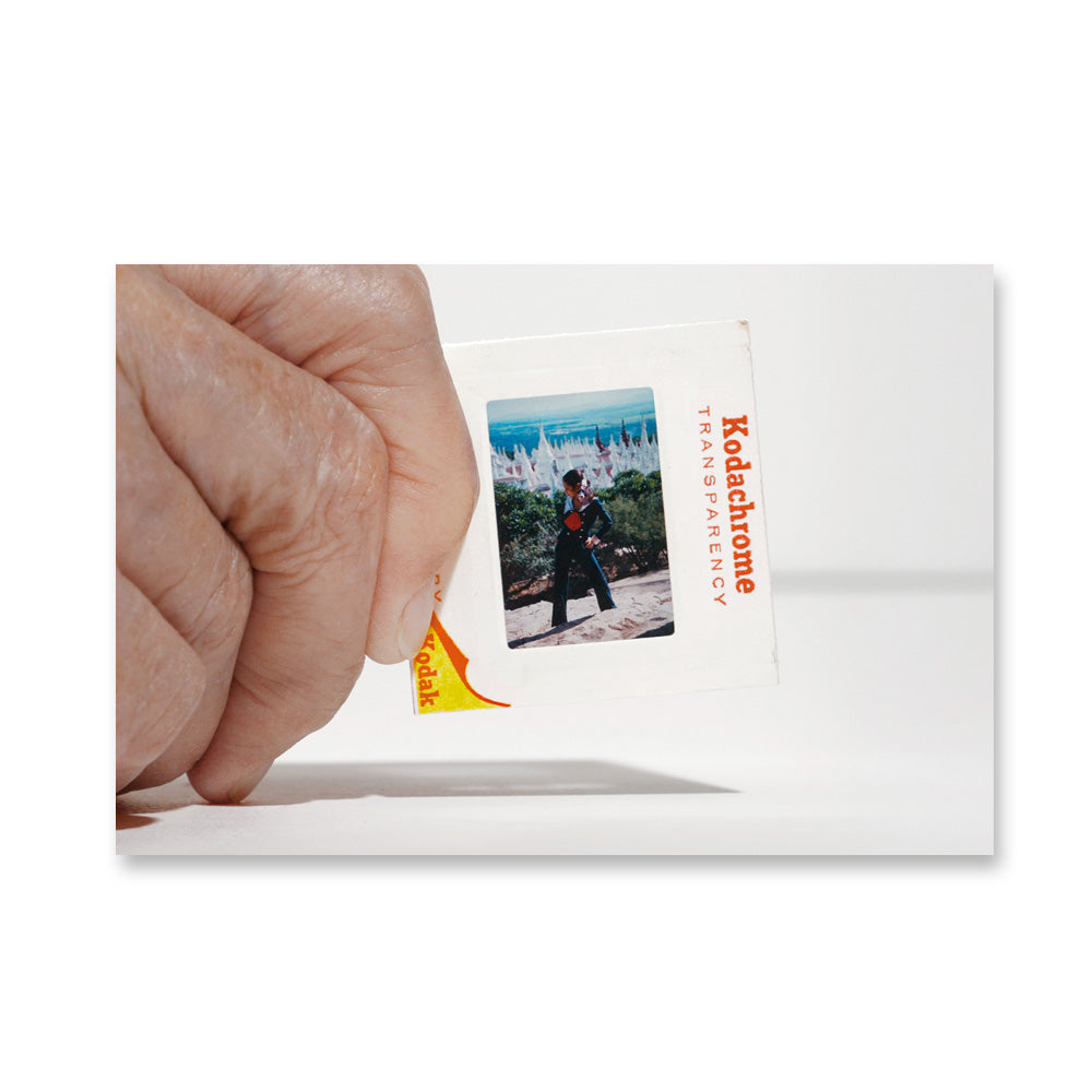 A hand holds a Taryn Simon Slides Post Card from the Guggenheim Museum, evoking conceptual photography.