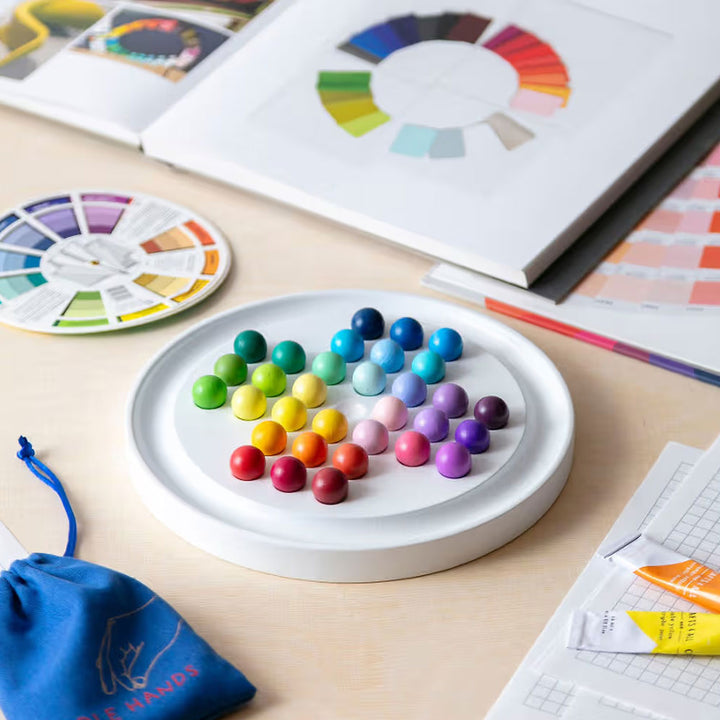 Gradient Solitaire by Guggenheim Museum features hand-painted balls arranged by hue, recalling a color theory puzzle.