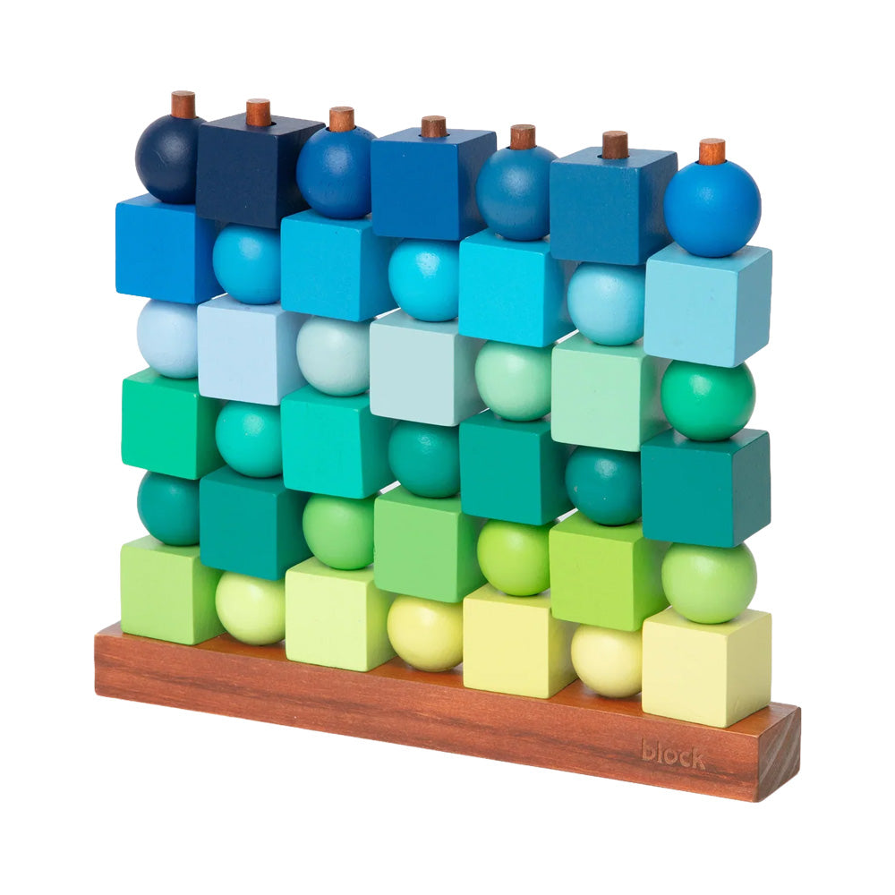 Guggenheim Museum’s Four in a Row Game features blue and green wooden pieces on a sturdy, playful puzzle base.