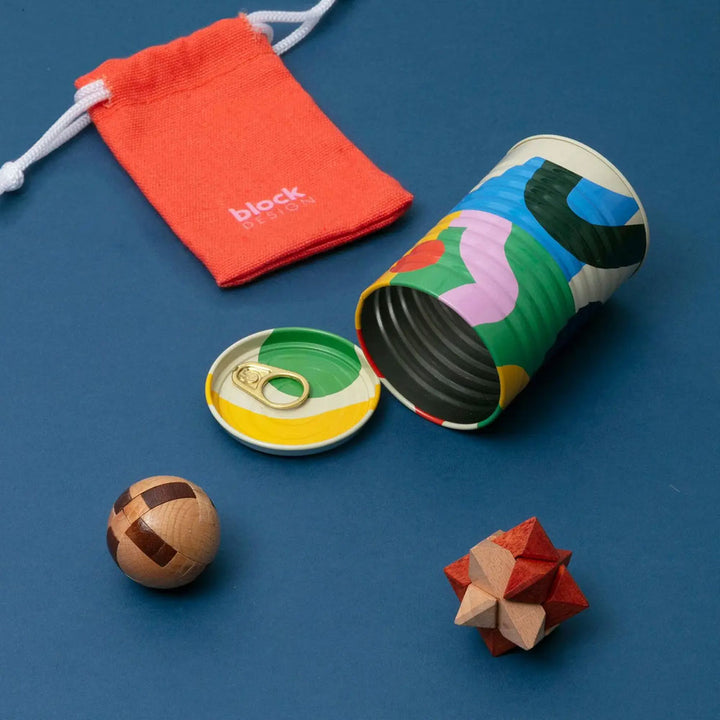 The Guggenheim Museum Tinned Goods Brain Tease Puzzle Duo gives educational fun in a tin with games and a red pouch.