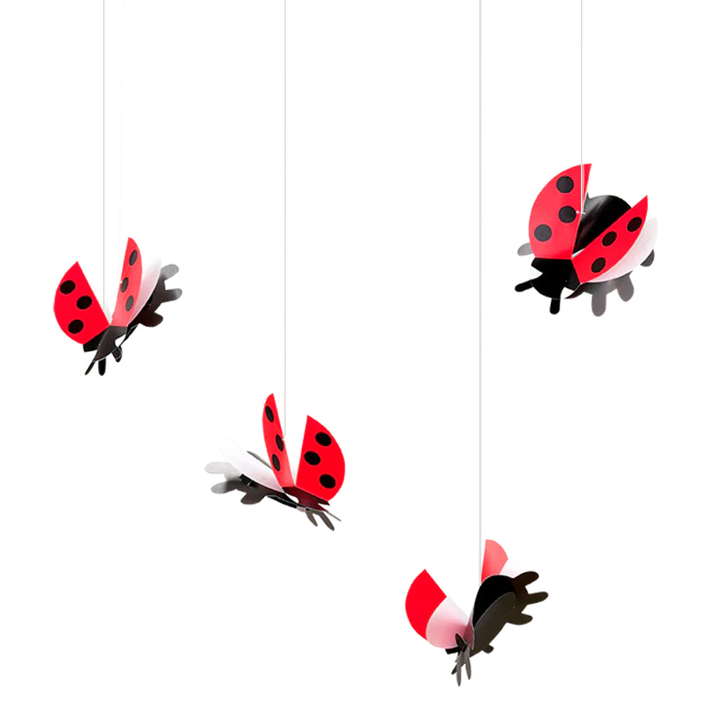 Four red and black Ladybird Flensted Mobiles by Guggenheim Museum hang, perfect for nursery visual tracking skills.