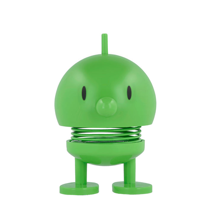 The Hoptimist x Humberto Cruz Art Lover Green Figure is a cartoonish toy with a dome head, oval eyes, round nose, coiled spring body, flat feet, and a short antenna—customized in vibrant green and inspired by Gustav Ehrenreich’s design.