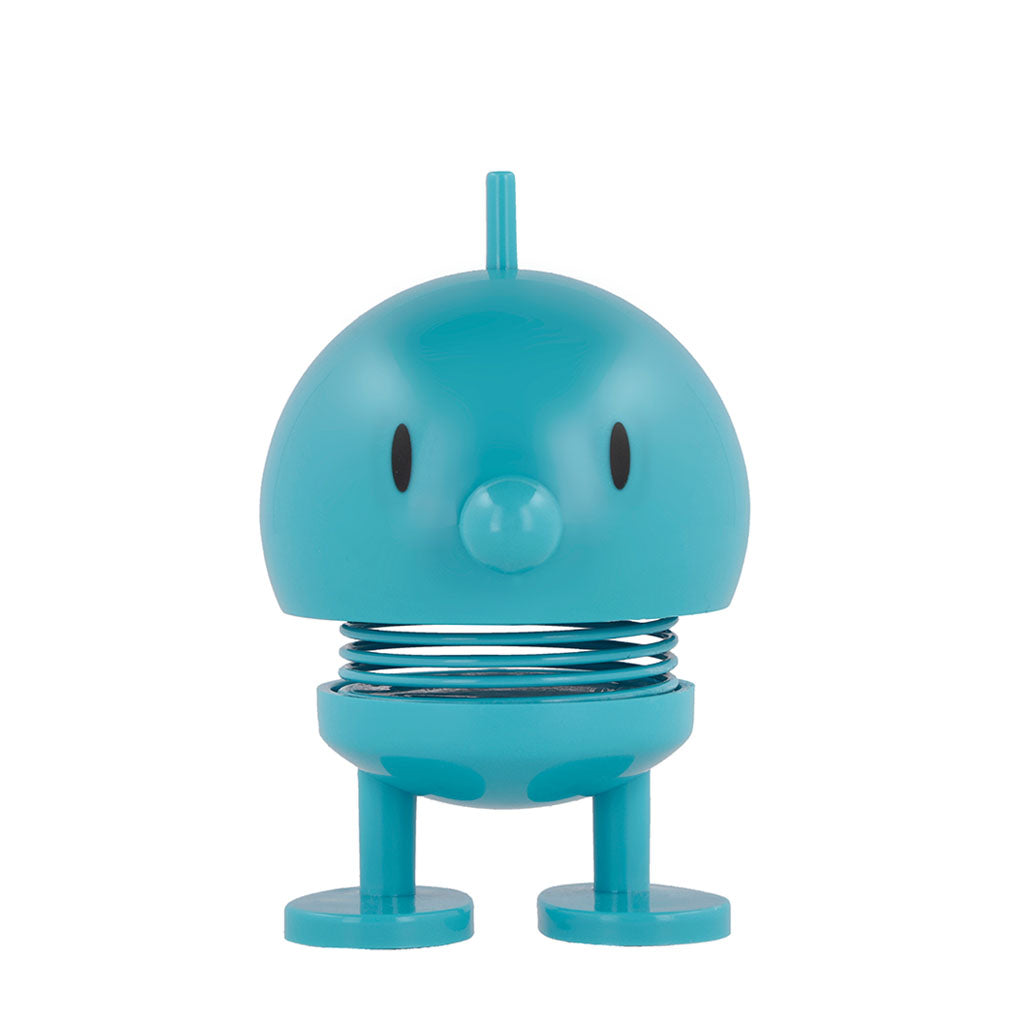 The Hoptimist x Humberto Cruz Art Lover Blue Figure is a round, cartoon-like toy with a springy body and simple face, standing upright on flat feet—a cheerful decor piece to brighten any space.