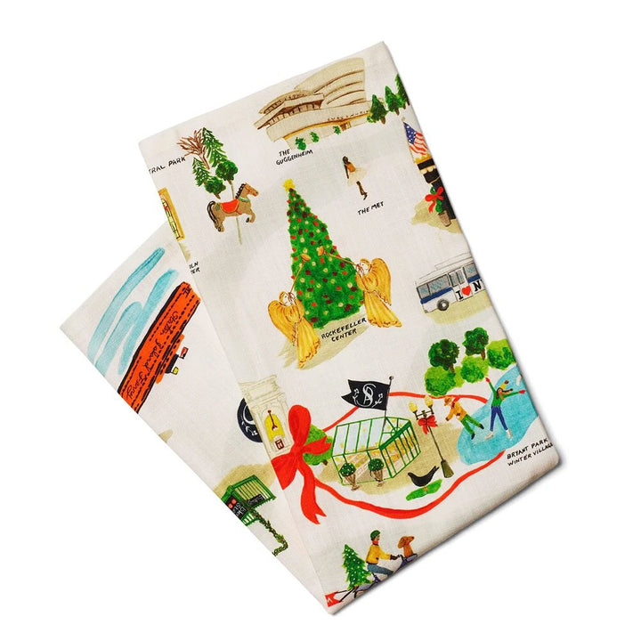 The Holiday in New York Tea Towel is VOC-certified and features colorful illustrations of New York City landmarks, such as a Christmas tree, angels, a museum, a bus, and other festive city scenes.