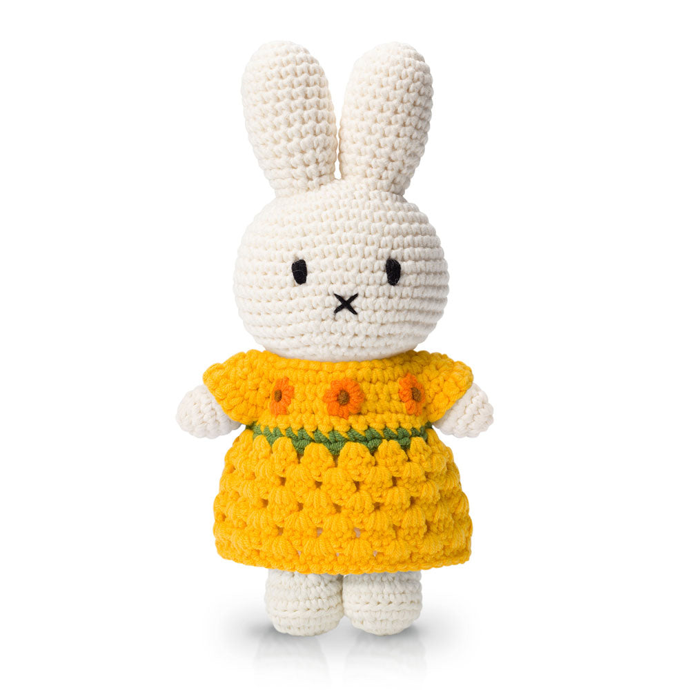 A crocheted white bunny toy in a Guggenheim Museum Van Gogh Miffy Sunflower Dress, against a white background.