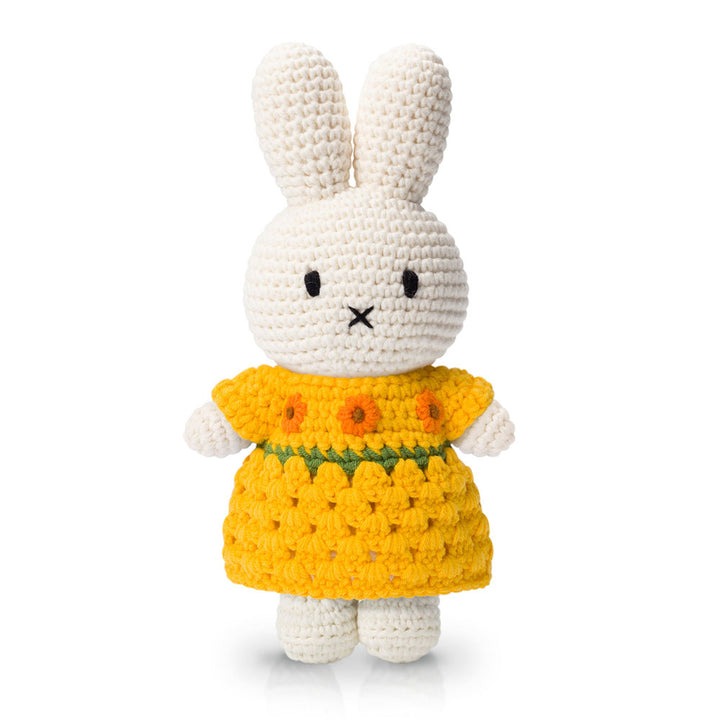 A crocheted white bunny toy in a Guggenheim Museum Van Gogh Miffy Sunflower Dress, against a white background.