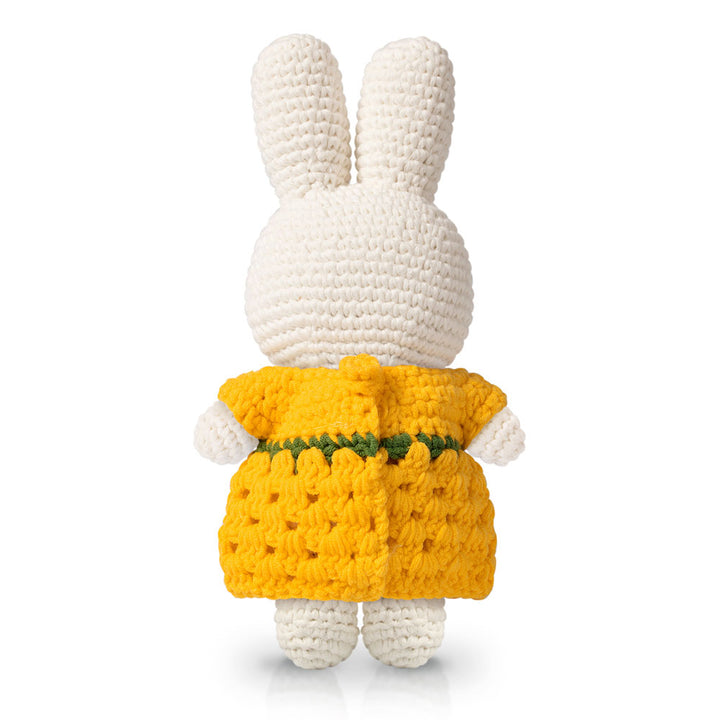 Van Gogh Miffy Sunflower Dress plush by Guggenheim Museum, white bunny in yellow dress with green waist stripe, facing away.